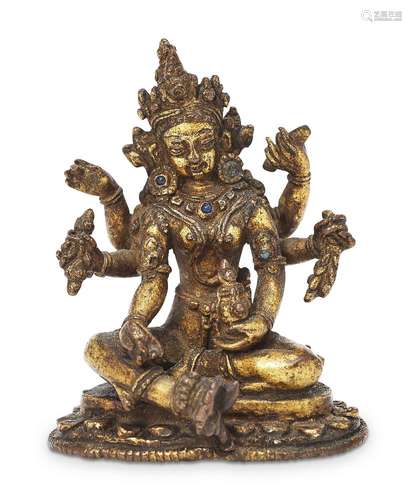 A Nepalese gilt bronze jewelled figure of Vasudhara, 15th/16th century, seated in lalitasana over