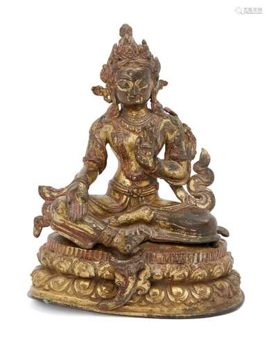 A Nepalese gilt bronze figure of Syamatara, 17th century, seated in lalitasana on a double lotus