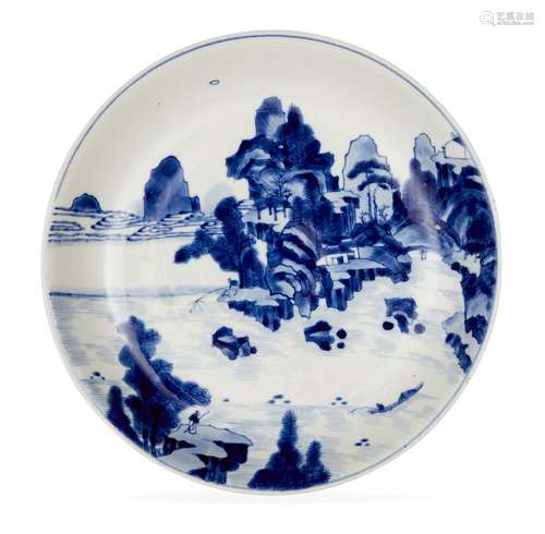 A Chinese porcelain dish, early 18th century, painted in underglaze blue with a scholar watching two