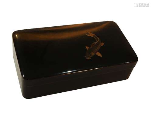 A Japanese lacquer box, 19th century, decorated with carp with inlaid eye against soft jimaki waves,