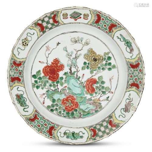 A large Chinese porcelain charger, Kangxi period, painted in famille verte enamels with flowering