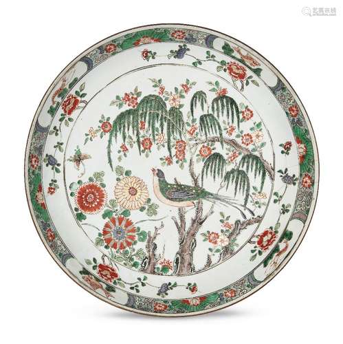 A large Chinese porcelain dish, Kangxi period, painted in famille verte enamels with a bird