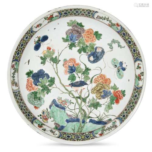 A large Chinese porcelain dish, Kangxi period, painted in famille verte enamels with a bird and