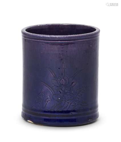 A Chinese monochrome porcelain brush pot, 17th century, with allover aubergine glaze, incised with