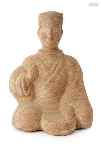 A Chinese teracotta figure of a musician, Han dynasty, modelled seated with a drum between his