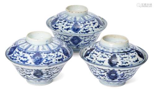 Three Chinese porcelain rice bowls and covers, 19th century, each painted in underglaze blue with