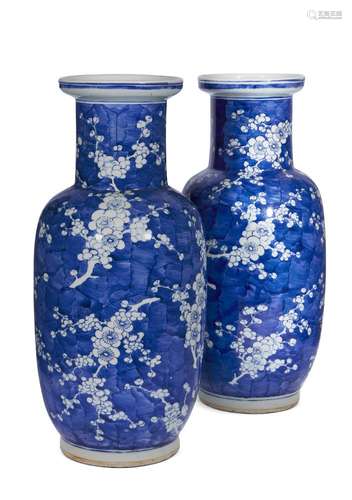 A pair of large Chinese porcelain rouleau vases, 19th century, painted in underglaze blue with