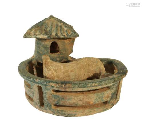 A Chinese pottery model of a pig house, Han dynasty, modelled with a single pig standing in a pen,