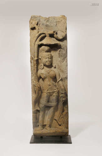 A LARGE INDIAN STONE CARVING OF AN ATTENDANT