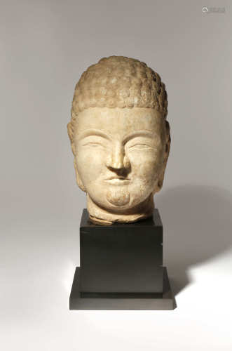 A CHINESE CARVED LIMESTONE HEAD OF BUDDHA