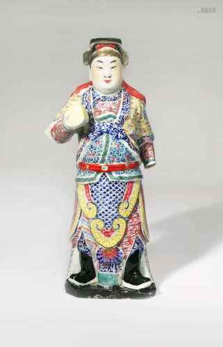 A CHINESE FAMILLE ROSE STANDING FIGURE