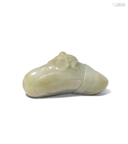 A CHINESE CELADON JADE CARVING OF A MONKEY ON A BOULDER