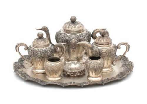 A Djokja tea service, comprising of; a teapot, milkjug, sugarpot, two small vases and six small
