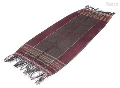 A tapis cloth rimmed with small beads. Lampung, Sumatra. Circa 1930.210 x 70 cm.- - -29.00 % buyer's