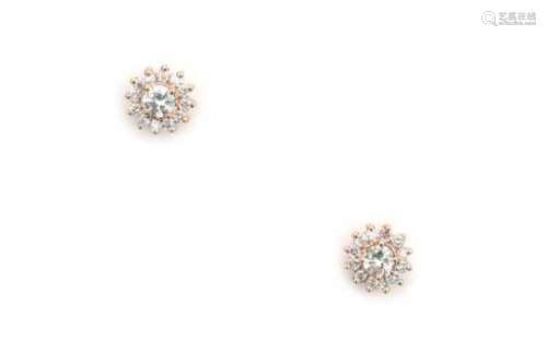 18 carat pink gold cluster diamond ear studs. Each stud is set with a center diamond of ca. 0.10 ct.