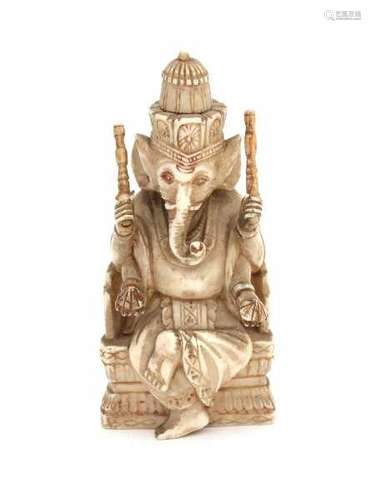 A Hindu ivory sculpture, Ganesh seated on a throne. Dressed in loose robes and with attributes in