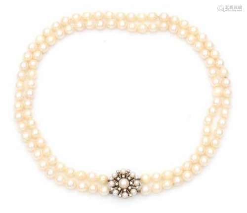 A double strand pearl necklace with 14 carat white gold diamond set clasp. Pearls are light