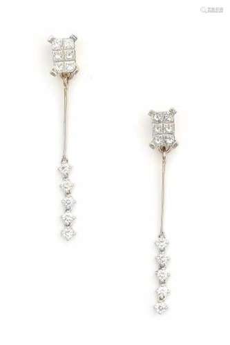 A pair of white gold earrings, made ca. 1970's - 1980's. Set with princess and brilliant cut