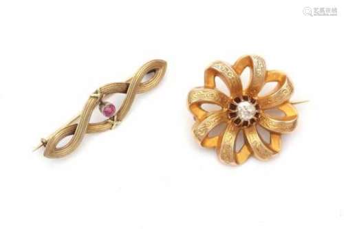 Two 14 carat yellow gold brooches. 19th century. One is set with a rose cut diamond and has diameter