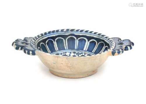 A Dutch maiolica porridge bowl, decorated with a monochrome blue pattern. Circa 1600Length 21 cm.- -