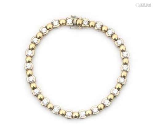 A bracelet with alternating 18 krt white and yellow gold links. The 22 white gold links are set with