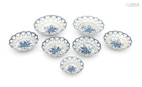 A collection of seven English blue and white baskets in three sizes, decorated in 'pine cone