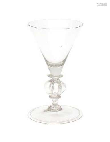 Two baluster wine glasses, one with four lobed stem, the other with an engraving around the rim.