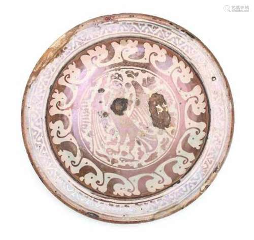 A Hispano-Moresque plate, decorated with a standing bird of prey in luster glaze. 17th