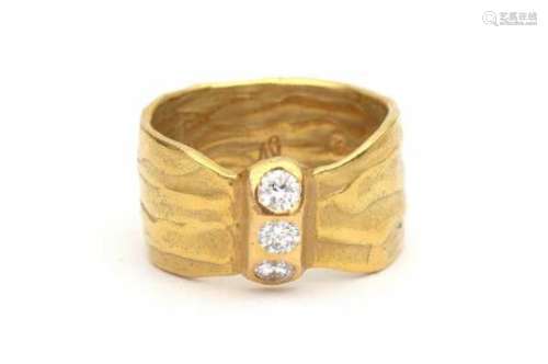 An 18 carat yellow gold modern ring, provenance Italy. Set with three brilliant cut Diamonds,