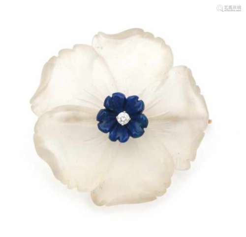 A carved rock crystal and lapis flower shaped brooch with yellow gold mount. Set with a brilliant
