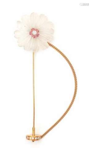 A carved rock crystal and pink tourmaline flower shaped lapel pin with yellow gold. Set with a