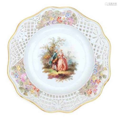 A pierced porcelain plate, decorated with a romantic couple in a landscape. The pierced edge with