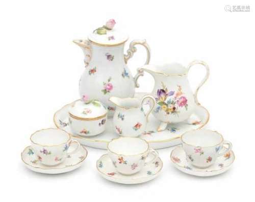 A porcelain coffee service, decorated with a variety of flowers. Comprising of; coffeepot, cream