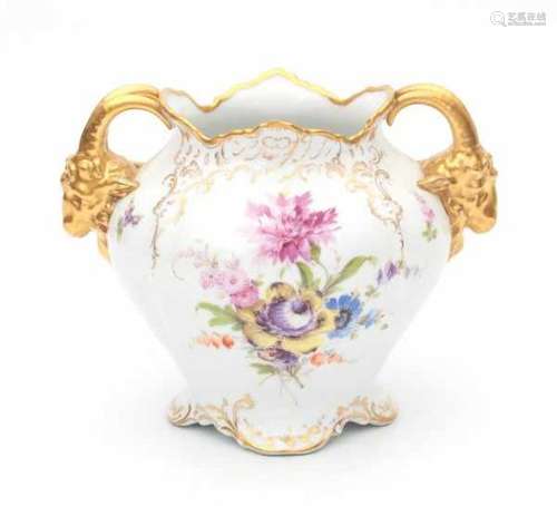 A part gilt porcelain vase, decorated with flowers. The handles in the shape of rams heads. Marked