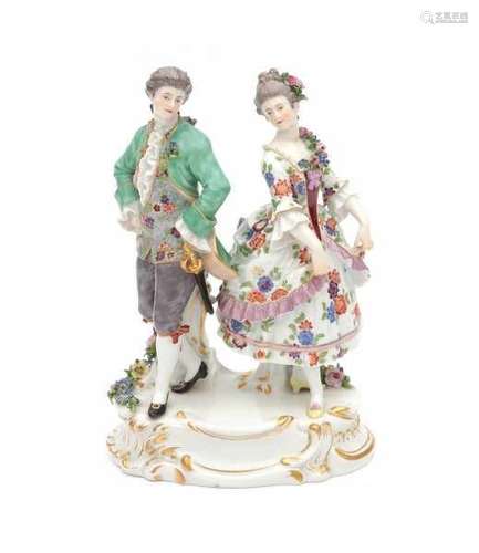 A porcelain group, dancing couple dressed in fine clothes. Marked with crossed swords, Meissen,