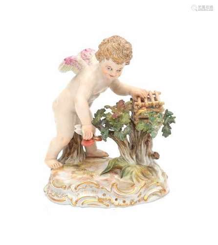 A porcelain figurine, Amor catching flying hearts. Marked with crossed swords and model 'O186'.