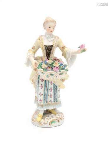 A porcelain figurine, flower girl with a basket of flowers and a rose in her hand. Marked with