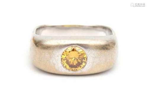 A white gold square solitaire ring, possibly by the hand of Kurt Aepli. Set with a fancy yellow,