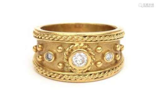An 18 carat yellow gold ring with rope work on satin finish by Dilaro, New York. Set with three