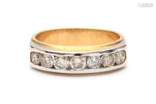 An 18 carat two tone contemporary gold ring. Set with seven brilliant cut diamonds, total ca. 0.80