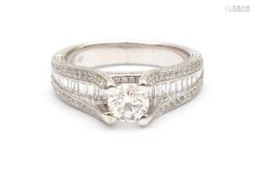 18 carat white gold brilliant and baguette cut diamond ring. Set with a brilliant cut diamond in the