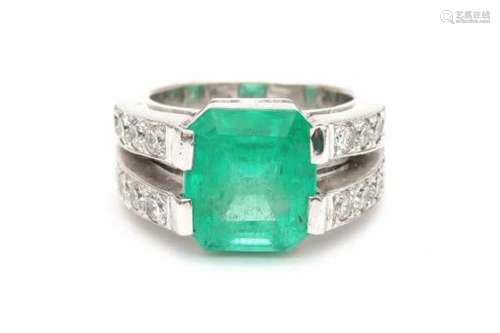 18 carat white gold ring with brilliant cut diamonds and a step cut emerald in the center. Emerald