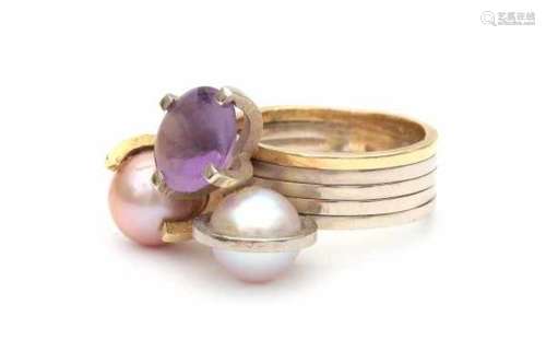 Two tone contemporary gold ring set with two cultured pearls and a buff top cut amethyst. Gross