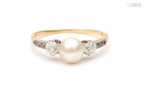 18 carat gold ring with a natural pearl in the center and two old European cut diamonds at the