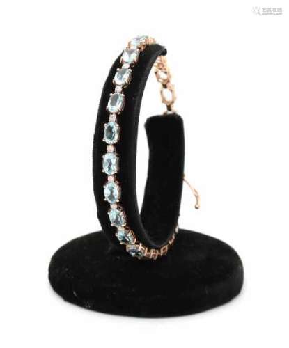 14 carat pink gold blue topaz and diamond line bracelet, set with oval cut topaz and single cut