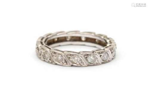 14 carat white gold and diamond eternity band, set with fifteen brilliant cut diamonds in a stylized