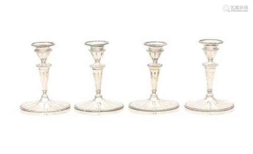 A set of four Dutch Sterling silver candlesticks. Maker's mark Fa. J.M. van Kempen & Zonen,