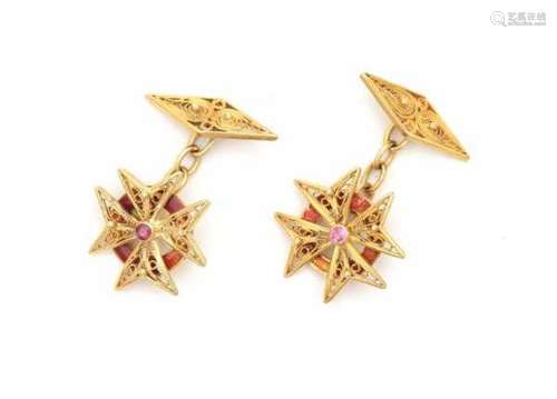 A pair of 18 carat gold cuff links set with rubies in the shape of a Malthese cross with a ruby in