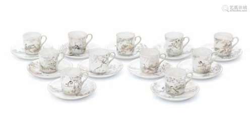 A set of eleven Japanese Satsuma mocca cup and saucers, decorated with various scenes of birds in