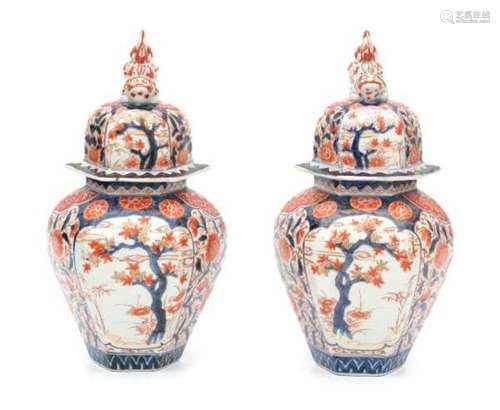 A pair of Japanese Imari lidded vazes, decorated with trees in two panels. Meiji period (1868-